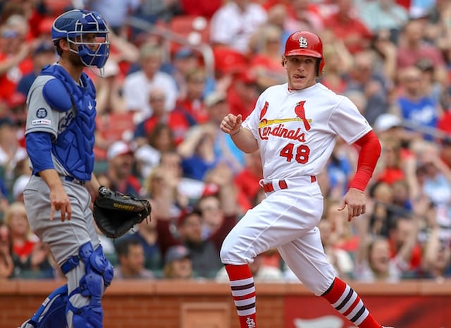 Los Angeles Dodgers catcher Austin Barnes looks on as St. Louis Cardinals outfielder Harrison Bader scores a run