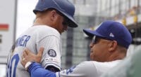 Los Angeles Dodgers manager Dave Roberts greets Justin Turner in the dugout at PNC Park