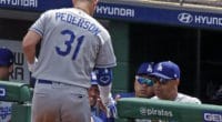 Los Angeles Dodgers manager Dave Roberts greets Joc Pederson in the dugout at PNC Park