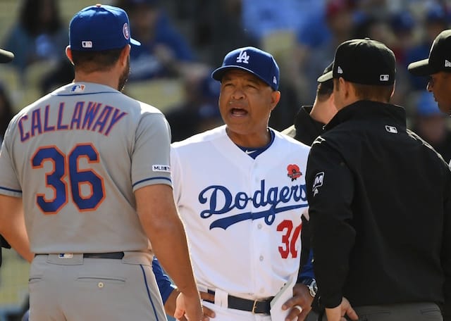 New York Mets manager Mickey Callaway and Los Angeles Dodgers manager Dave Roberts speak with umpires prior to a game at Dodger Stadium
