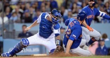 Los Angeles Dodgers catcher Will Smith applies a tag at home plate during a game against the New York Mets