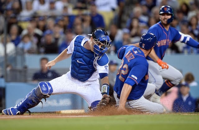 Los Angeles Dodgers catcher Will Smith applies a tag at home plate during a game against the New York Mets
