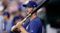 Los Angeles Dodgers starting pitcher Clayton Kershaw holds a bat in the dugout at Coors Field