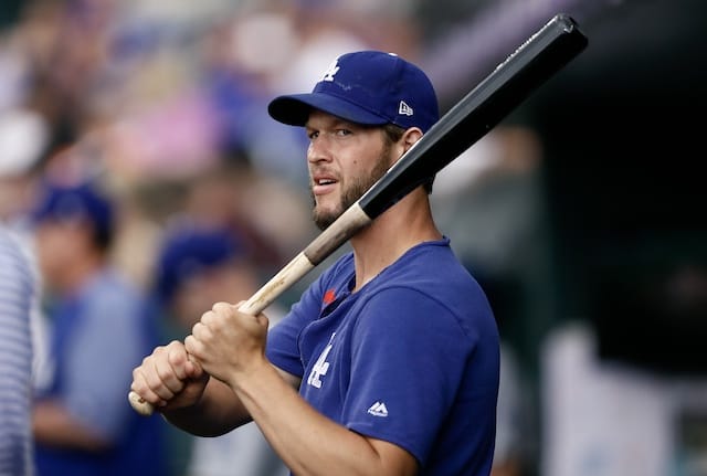Los Angeles Dodgers starting pitcher Clayton Kershaw holds a bat in the dugout at Coors Field