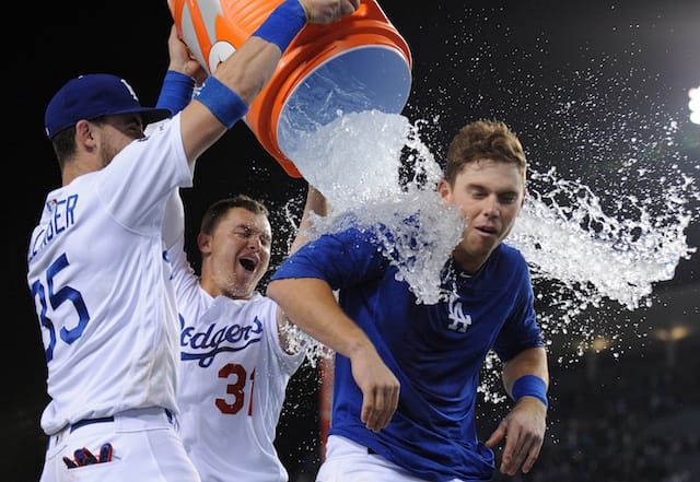 Los Angeles Dodgers teammates Cody Bellinger and Joc Pederson empty a Gatorade cooler on Will Smith after his walk-off home run