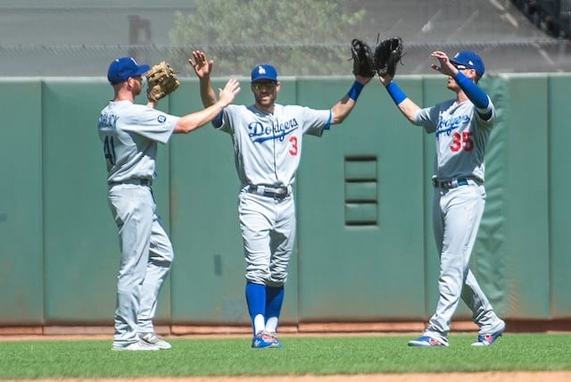 Los Angeles Dodgers outfielders Cody Bellinger, Kyle Garlick and Chris Taylor celebrate after a win against the San Francisco Giants