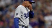 Los Angeles Dodgers manager Dave Roberts walks back to the dugout at Coors Field