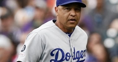 Los Angeles Dodgers manager Dave Roberts runs onto the field for a pitching change against the Colorado Rockies