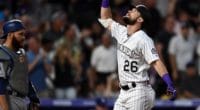 Los Angeles Dodgers catcher Russell Martin looks on as Colorado Rockies left fielder celebrates a home run at Coors Field
