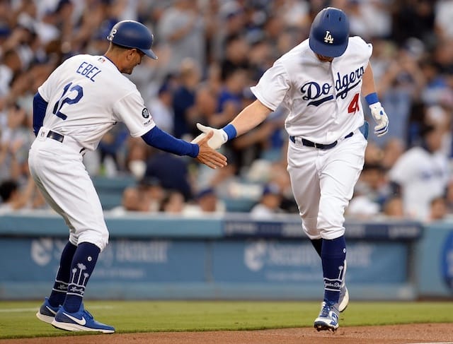 Los Angeles Dodgers third base coach Dino Ebel greets Kyle Garlick after his first career home run