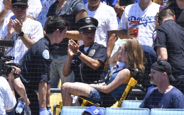 Fan is taken away from a game at Dodger Stadium after being hit by a foul ball