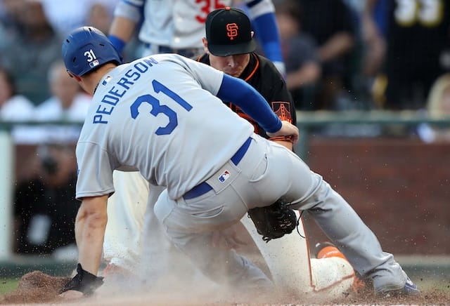 Los Angeles Dodgers outfielder Joc Pederson is tagged on his slide into home plate