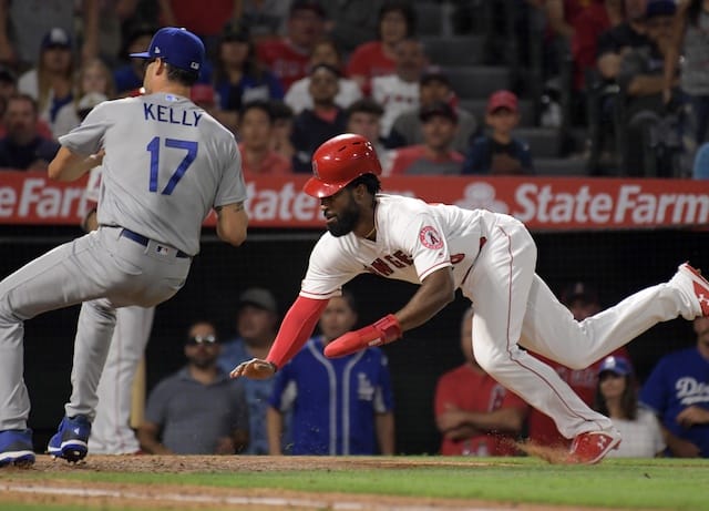 Los Angeles Dodgers relief pitcher Joe Kelly covers home plate after throwing a wild pitch