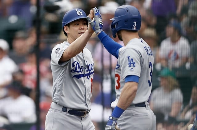 Los Angeles Dodgers starting pitcher Kenta Maeda celebrates with Chris Taylor after scoring against the Colorado Rockies