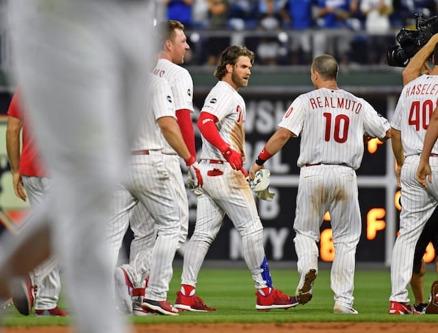 Philadelphia Phillies teammates Bryce Harper and J.T. Realmuto celebrate after a walk-off win against the Los Angeles Dodgers