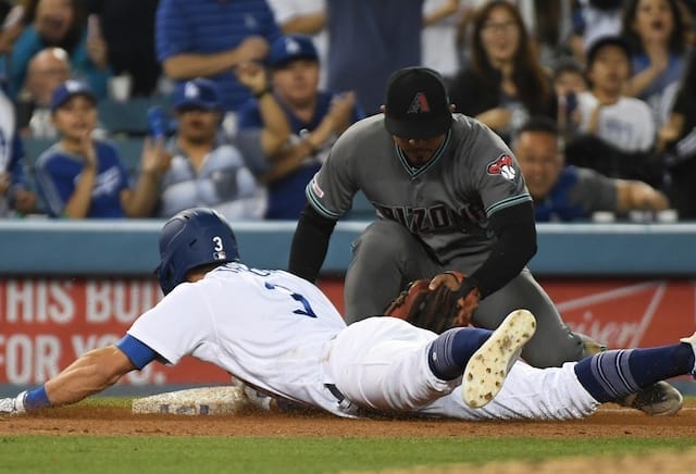 Los Angeles Dodgers shortstop Chris Taylor slides into third base on a triple against the Arizona Diamondbacks
