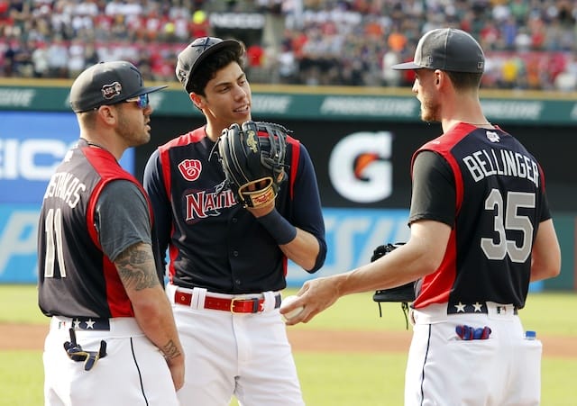 Los Angeles Dodgers right fielder Cody Bellinger and Milwaukee Brewers teammates Mike Moustakas and Christian Yelich speak during a 2019 All-Star Game workout at Progressive Field