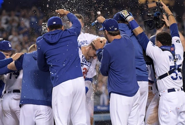 Cody Bellinger, Russell Martin and the Los Angeles Dodgers celebrate after a walk-off win against the Arizona Diamondbacks