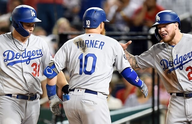 Los Angeles Dodgers teammates Joc Pederson, Justin Turner and Alex Verdugo celebrate after a home run against the Washington Nationals
