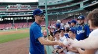 Los Angeles Dodgers relief pitcher Joe Kelly signs autographs for fans prior to a game against the Boston Red Sox at Fenway Park