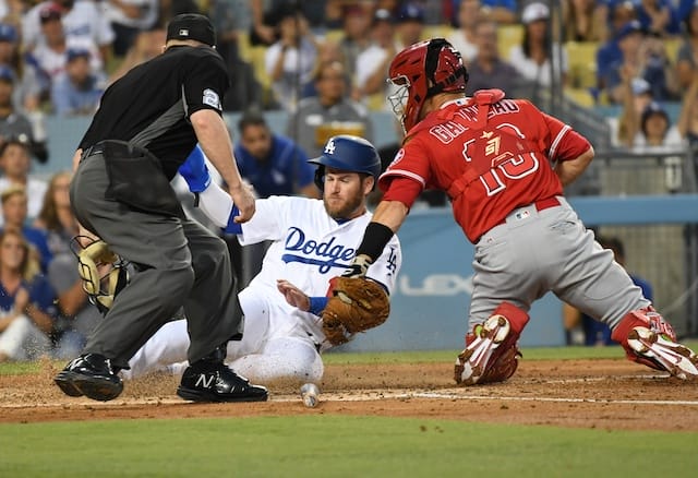 Los Angeles Dodgers first baseman Max Muncy is out at home plate