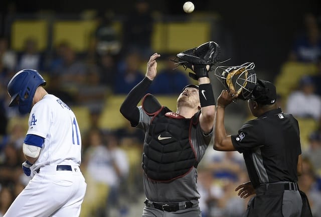 Los Angeles Dodgers center fielder A.J. Pollock reacts after being hit by a pitch