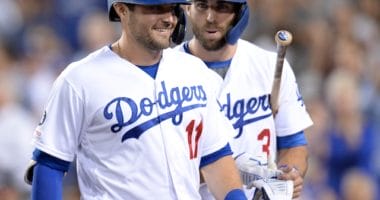 Los Angeles Dodgers teammates A.J. Pollock and Chris Taylor react