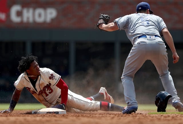 Los Angeles Dodgers shortstop Corey Seager tags Atlanta Braves outfielder Ronald Acuña Jr. on a stolen base attempt