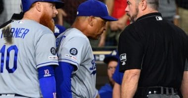 Los Angeles Dodgers manager Dave Roberts and Justin Turner argue with umpire Rob Drake