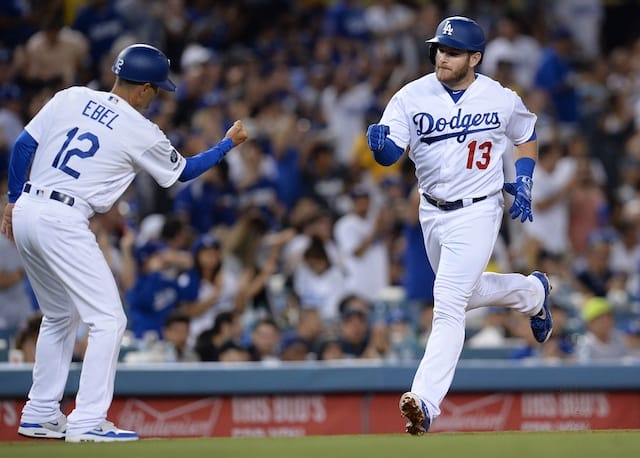 Los Angeles Dodgers third base coach Dino Ebel celebrates with Max Muncy after a home run