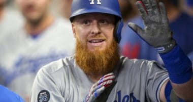 Los Angeles Dodgers third baseman Justin Turner is congratulated in the dugout after hitting a home run