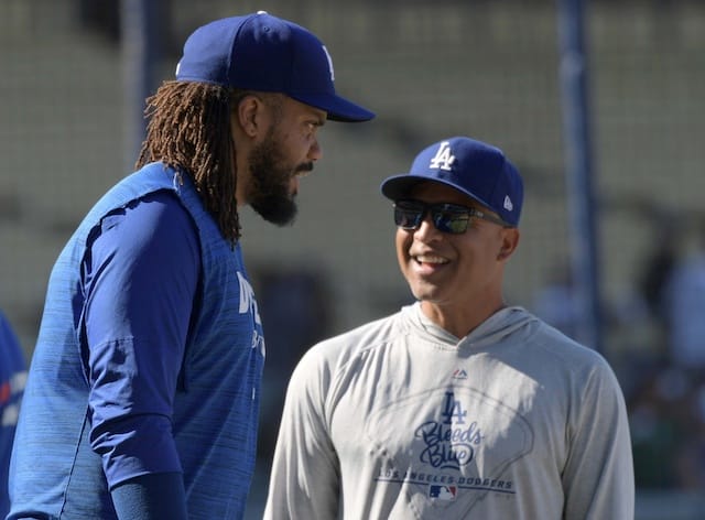 Los Angeles Dodgers manager Dave Roberts speaks with Kenley Jansen during batting practice at Dodger Stadium