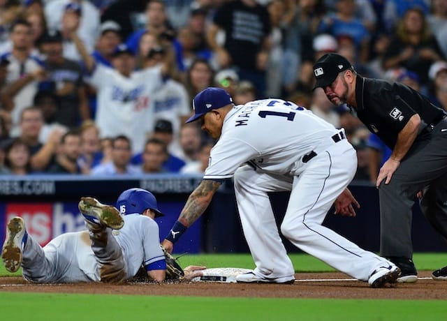 San Diego Padres third baseman Manny Machado attempts to tag out Los Angeles Dodgers catcher Will Smith