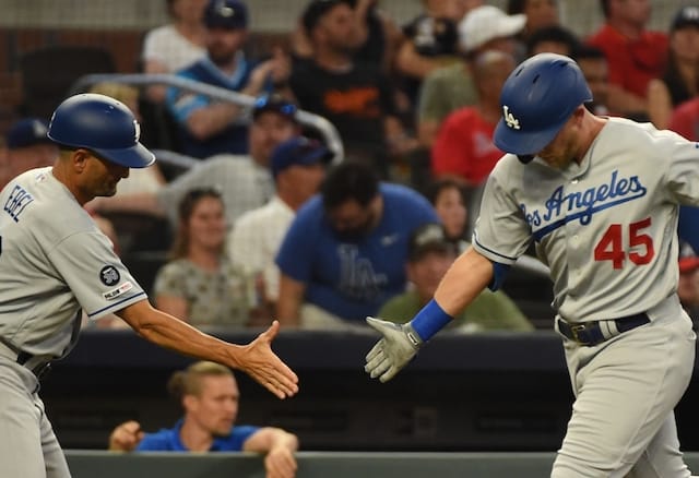 Los Angeles Dodgers third base coach Dino Ebel congratulates Matt Beaty after hitting a home run against the Atlanta Braves