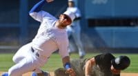New York Yankees center fielder Brett Gardner slides into Los Angeles Dodgers second baseman Max Muncy