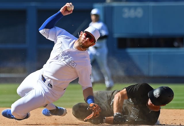 New York Yankees center fielder Brett Gardner slides into Los Angeles Dodgers second baseman Max Muncy