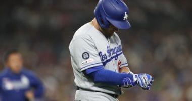 Los Angeles Dodgers infielder Max Muncy holds his right wrist after being hit by a pitch