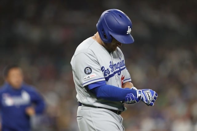 Los Angeles Dodgers infielder Max Muncy holds his right wrist after being hit by a pitch