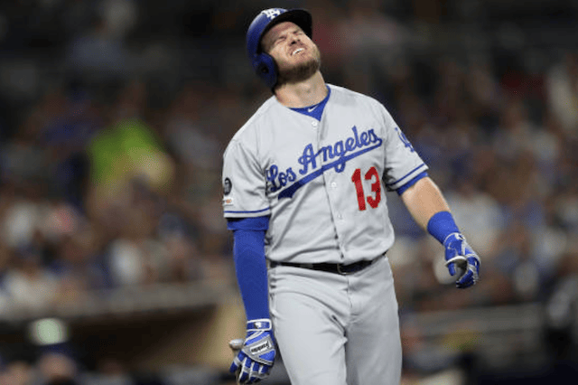 Los Angeles Dodgers infielder Max Muncy reacts after being hit by a pitch