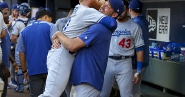Los Angeles Dodgers teammates Rich Hill and Justin Turner embrace before a game at SunTrust Park