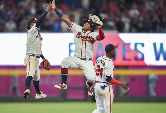 Atlanta Braves teammates Ronald Acuña Jr., Ozzie Albies and Adeiny Hechavarría celebrate after a win against the Los Angeles Dodgers
