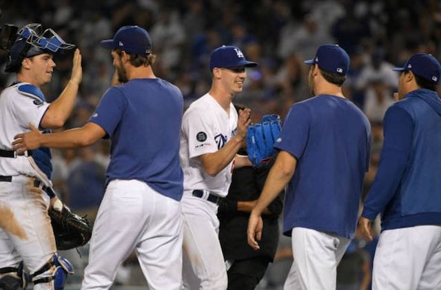 Walker Buehler, Rich Hill, Clayton Kershaw, Hyun-Jin Ryu and Will Smith celebrate after a Los Angeles Dodgers win