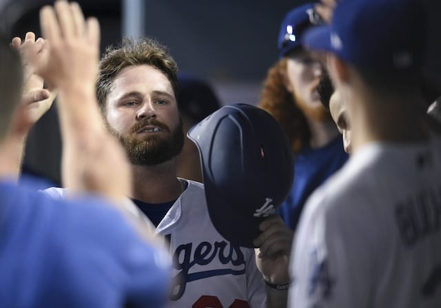 Los Angeles Dodgers first baseman Tyler White is congratulated in the dugout