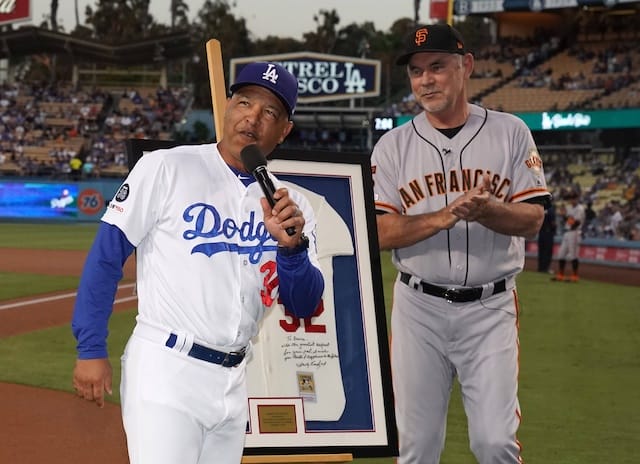 Los Angeles Dodgers manager Dave Roberts presents San Francisco Giants manager Bruce Bochy with an autographed Sandy Koufax jersey as a retirement gift