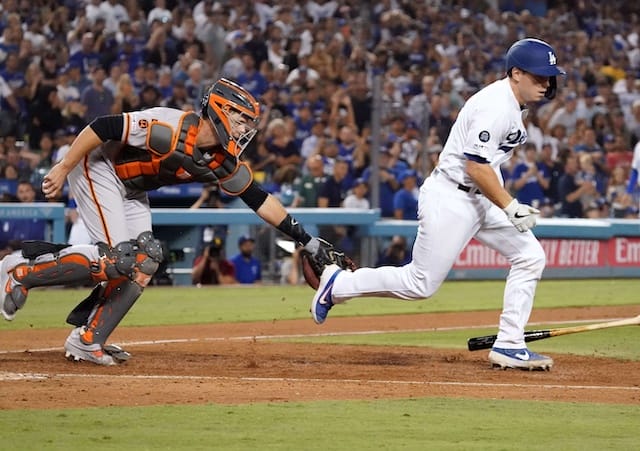 San Francisco Giants catcher Buster Posey attempts to tag Los Angeles Dodgers catcher Will Smith on a strikeout
