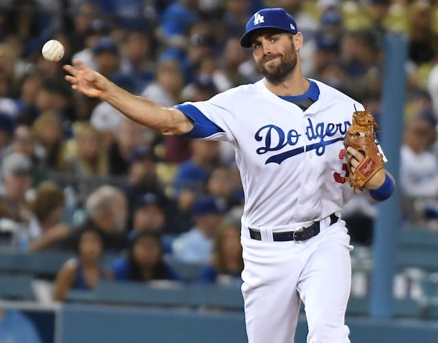 Los Angeles Dodgers utility player Chris Taylor throws the ball to first base