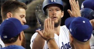 Los Angeles Dodgers pitcher Clayton Kershaw is congratulated in the dugout