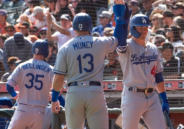Los Angeles Dodgers teammates Cody Bellinger, Gavin Lux and Max Muncy celebrate during a game against the San Francisco Giants