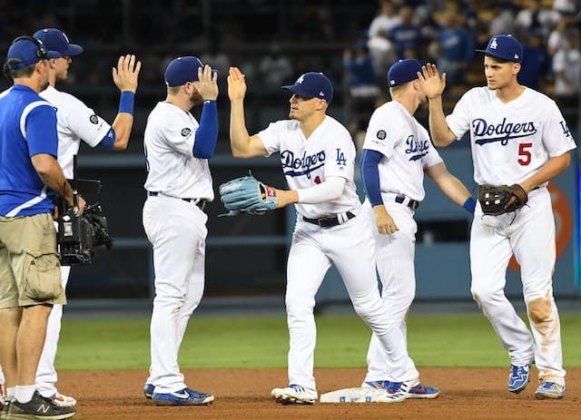 Los Angeles Dodgers teammates Cody Bellinger, Kiké Hernandez, Gavin Lux, Max Muncy and Corey Seager celebrate after a win