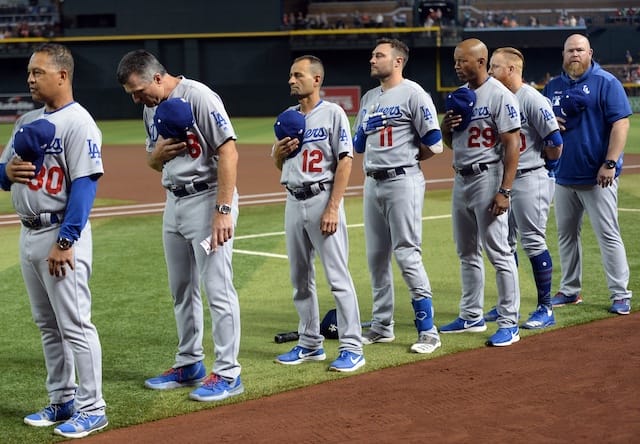 Los Angeles Dodgers manager Dave Roberts, bench coach Bob Geren, first base coach George Lombard, third base coach Dino Ebel and Justin Turner lined up for the national anthem